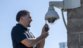 person with avigilon camera outside