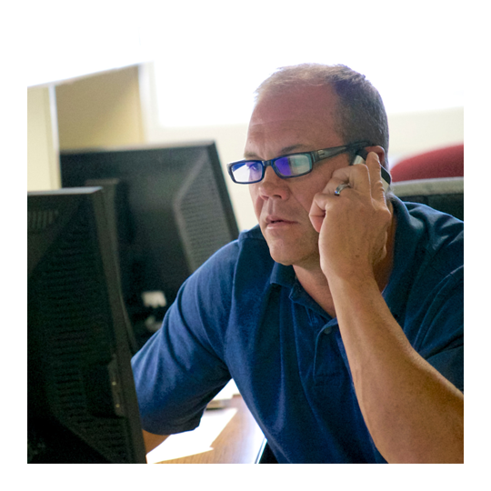 Person completing risk assessment report on desktop computer.