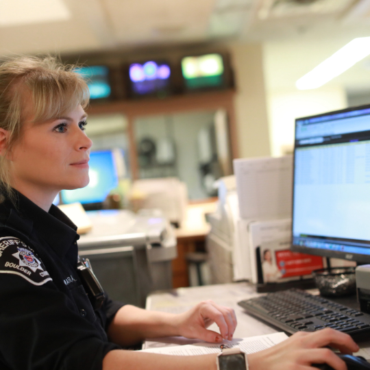 Police officer working at desk in office