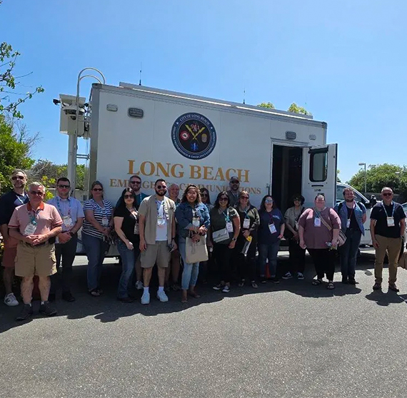 Group of 9-1-1 leaders in front of an emergency vehicle