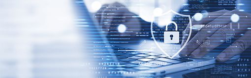 Person types on a laptop with graphics representing cybersecurity