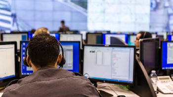 Motorola employee working in control center with monitors