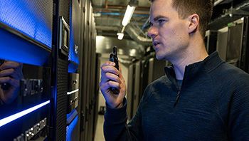 Person using a two-way radio in a server room