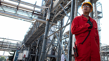 Oil and gas worker using a two-way radio