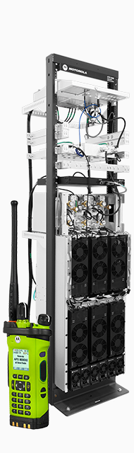 Image of an APX radio next to an ASTRO site equipment