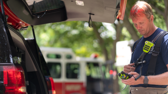 Firefighter holding radio 