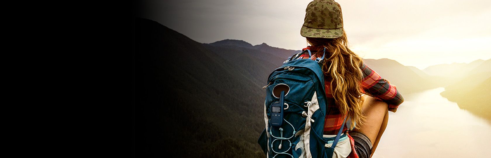 Hiker near a lake with TALKABOUT radio