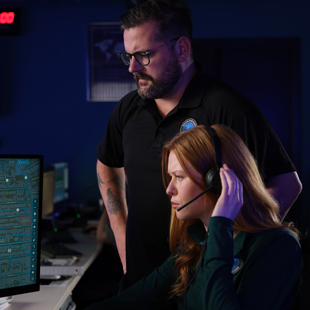 Man and woman with headset looking at desktop