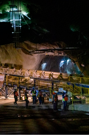 Man speaking into radio outside a manufacturing plant