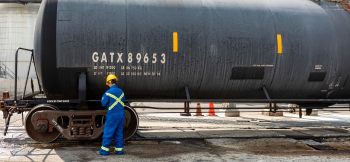 Oil and gas worker secures oil cargo. 