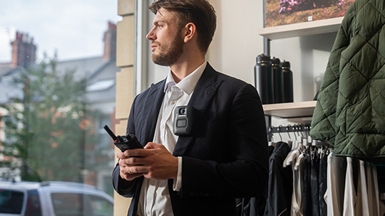 Retail employee typing on radio