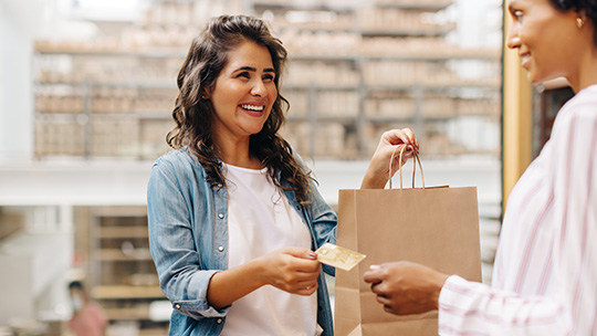 Customer handing cash to store employee