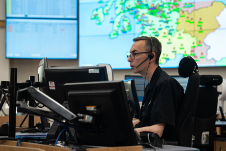 Control room operator monitoring digital screens