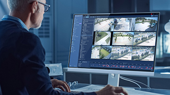 Man watching video feeds on computer