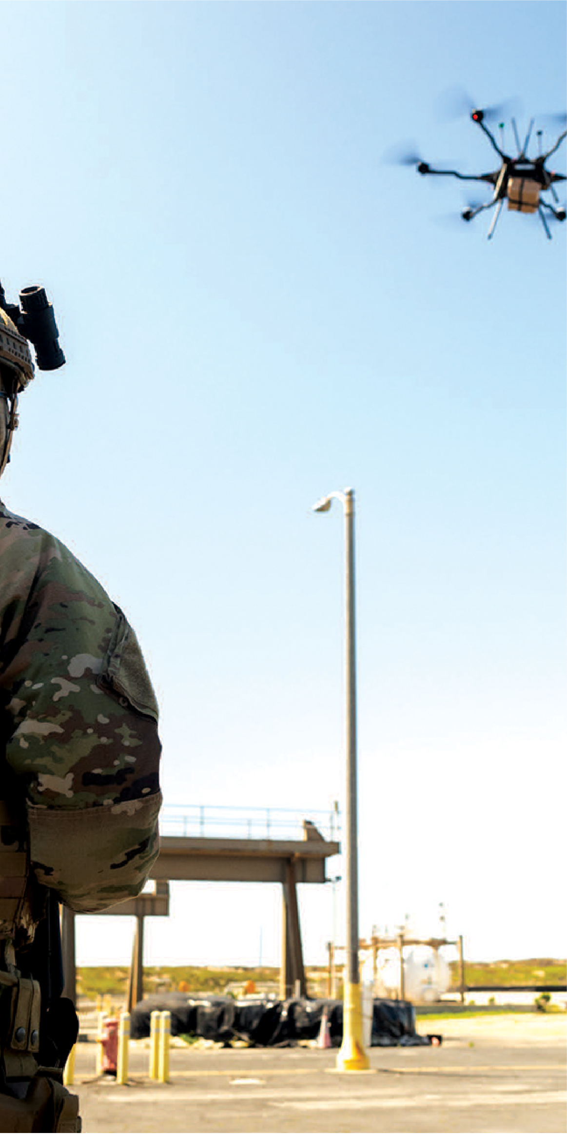 Image of military person in camouflage outfit operating a drone 