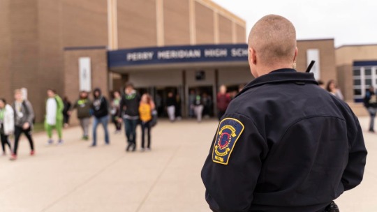 A police officer arrives at a high school